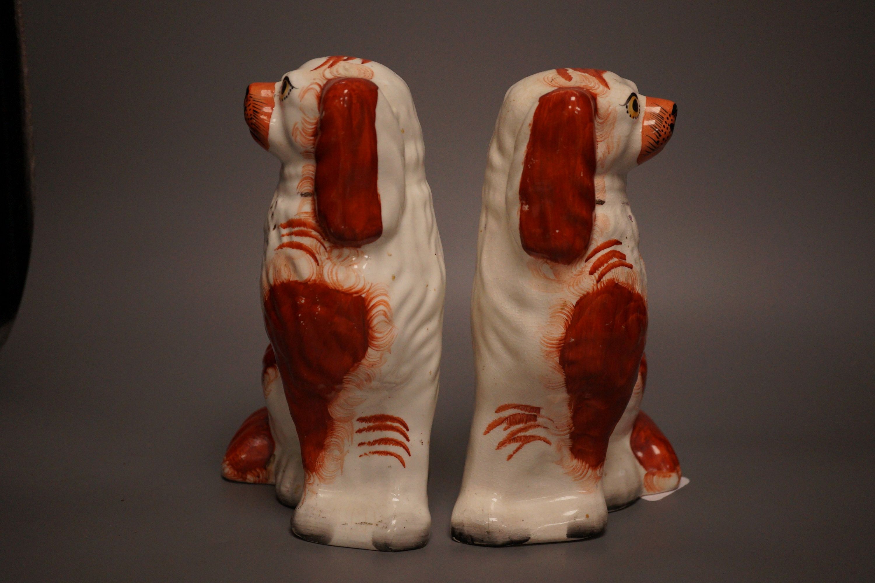 A pair of Staffordshire pottery King Charles spaniel’s, 24cm